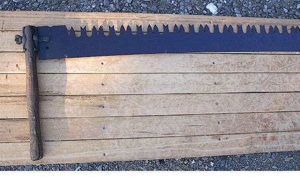 for a terrific antique crosscut saw Has its original wooden handles 